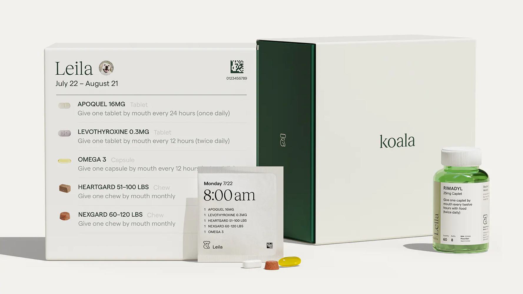 A set of pet medication supplies. The set includes a white box labeled "Leila" with a list of medications and dosages, a green and white Koala branded box, a medicine bottle, and various colored tablets.