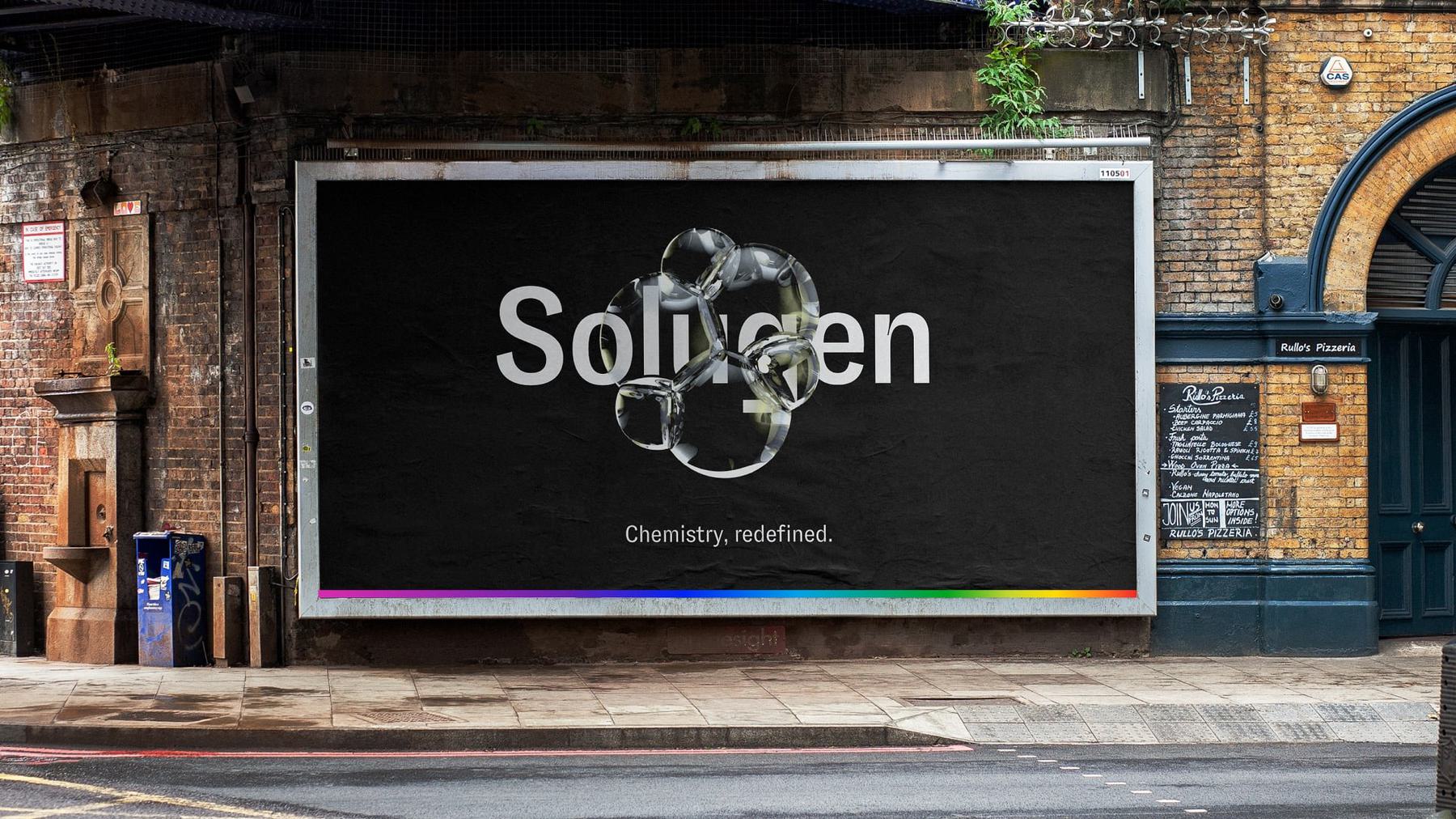 A large outdoor advertising billboard on a brick wall displays an ad for "Solugen." The slogan beneath reads, "Chemistry, redefined."